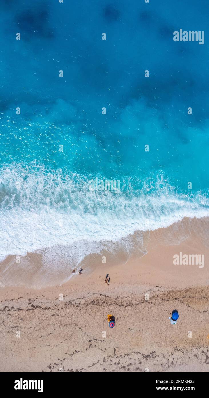 Aerial drone aerial shot in summer on paradise sandy beach Megali Petra in Lefkada. Beautiful crystal clear turquoise and blue waters. Greece. Stock Photo