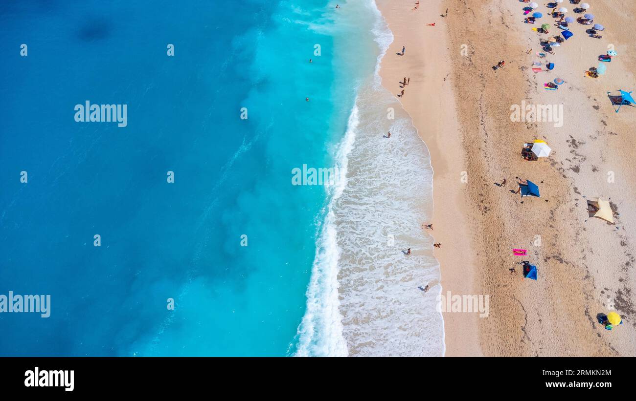 Aerial drone aerial shot in summer on paradise sandy beach Megali Petra in Lefkada. Beautiful crystal clear turquoise and blue waters. Greece Stock Photo
