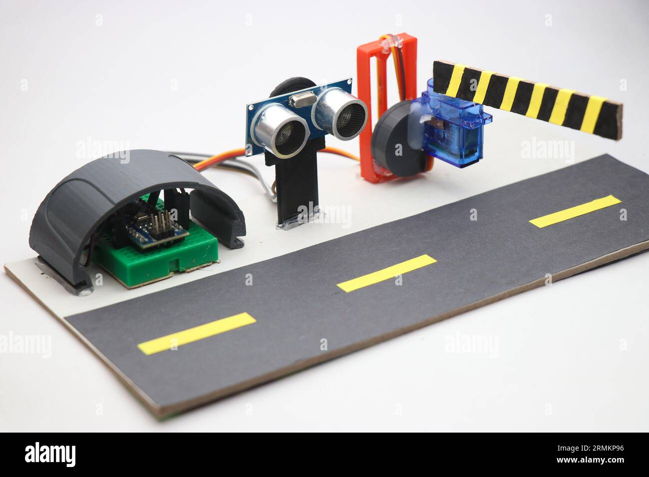 Electronic components with programmable microcontrollers are connected to a Breadboard and ultrasonic sensor making an automatic barrier system Stock Photo