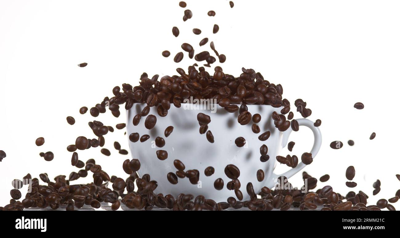 Coffee Beans Falling into a Cup against White Background Stock Photo ...