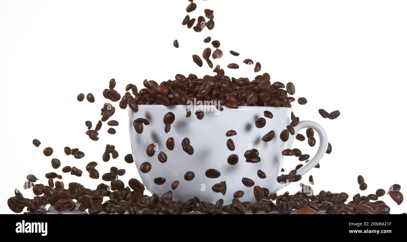 Coffee Beans Falling into a Cup against White Background Stock Photo ...