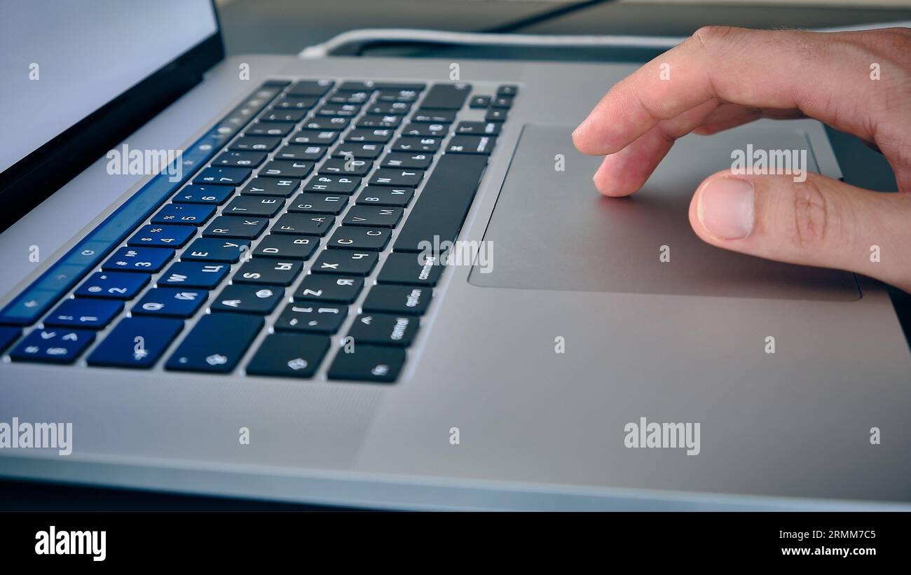 Hand on laptop touchpad Stock Photo
