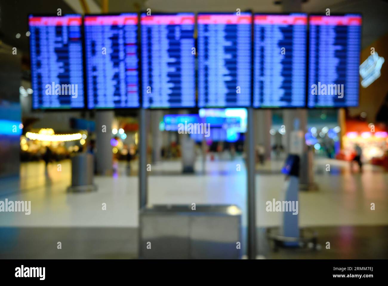 Defocused display in airport lounge showing arrival and departure time. Blurred flight schedules in airport Stock Photo