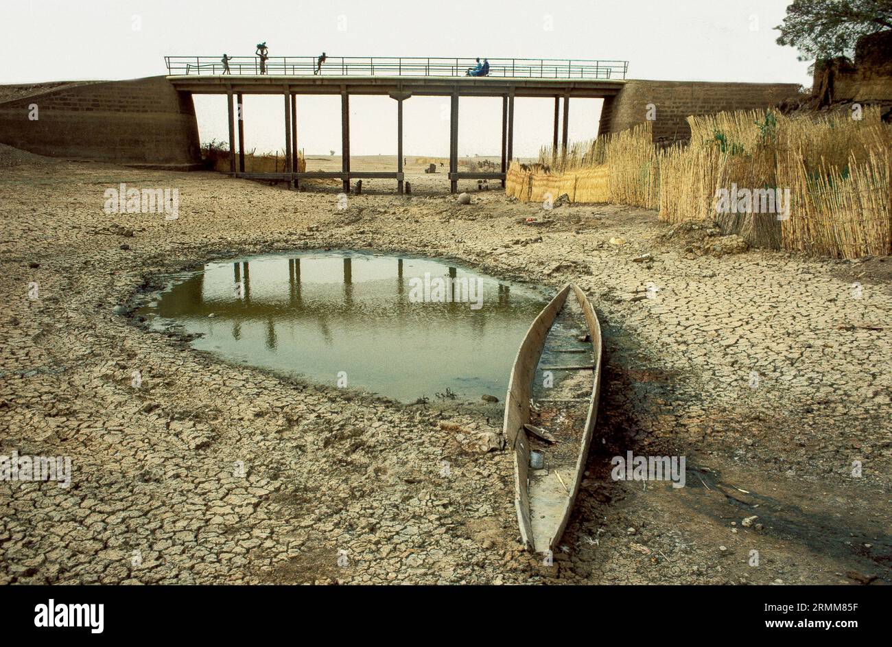 Mali, Sahel. Boat in a riverbed that has almost completely run dry. Stock Photo