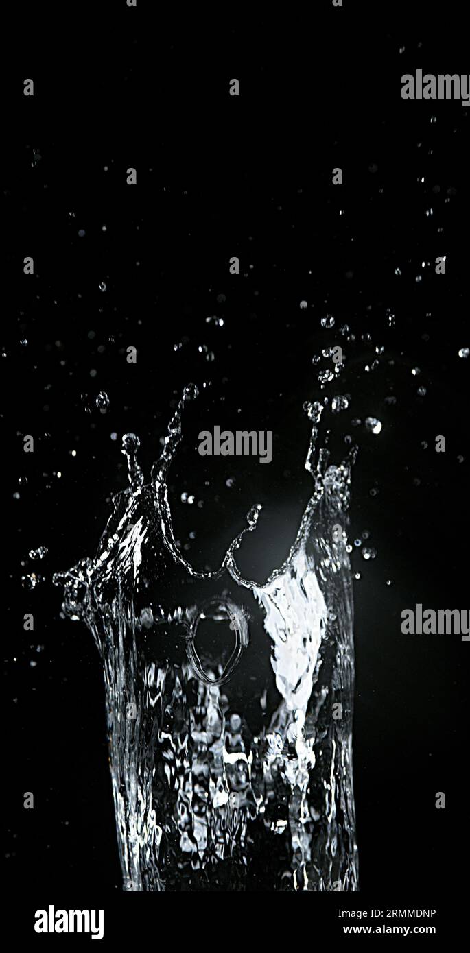 Water spurting out against Black Background Stock Photo - Alamy