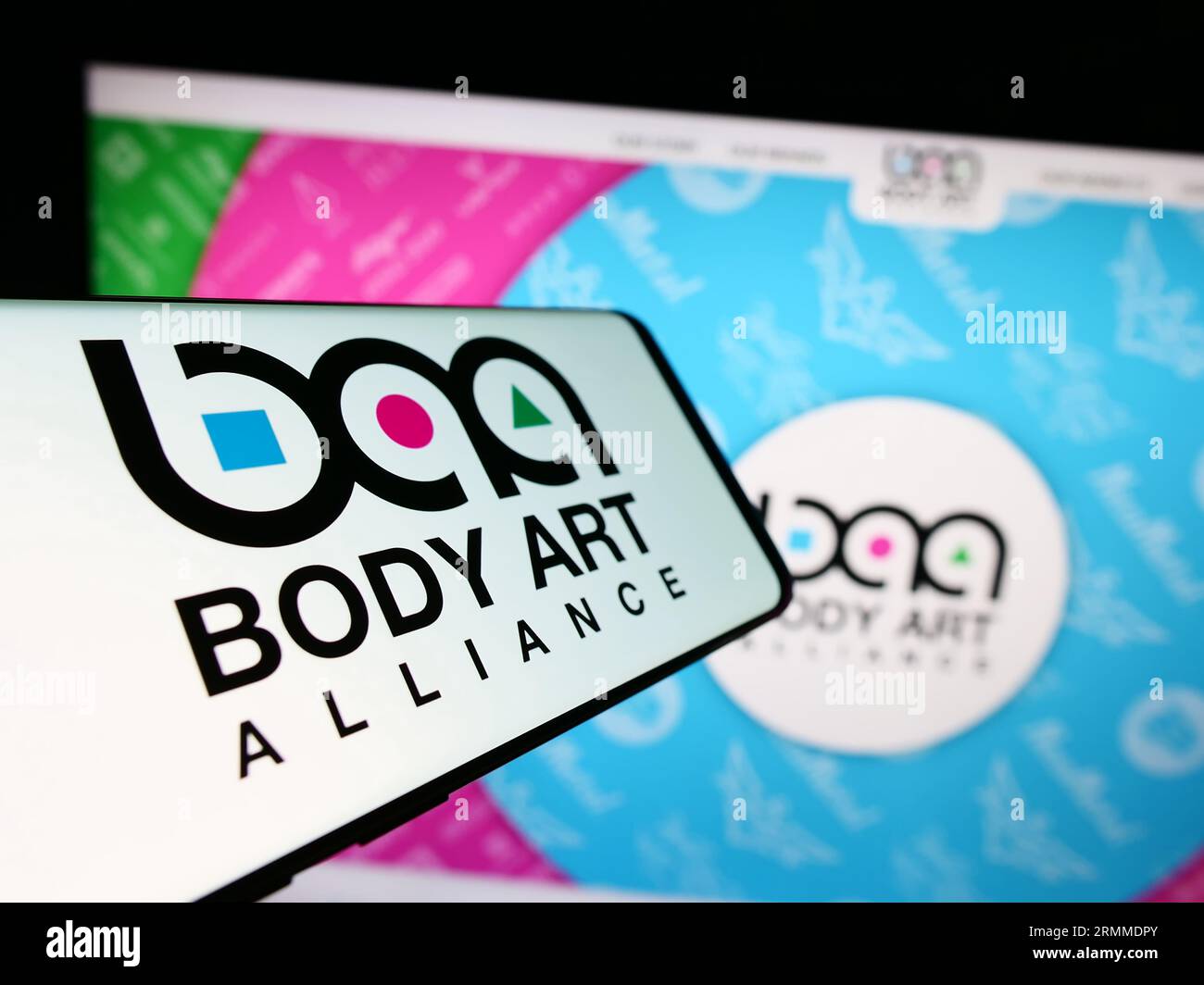 Smartphone with logo of American cosmetics company Body Art Alliance on screen in front of website. Focus on center-left of phone display. Stock Photo