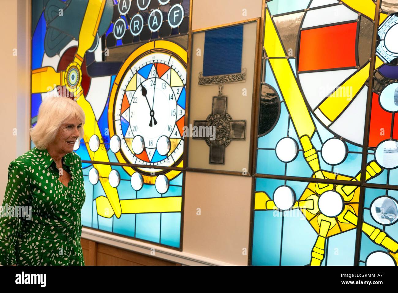 Queen Camilla is shown stained glass windows that celebrate 100 years of women in support of and service in the RAF at the Royal Air Force Club in Piccadilly, central London, where she unveiled a portrait of Special Operations Executive (SOE) Operative, Noor-un-Nisa Inayat Khan GC, and formally announced the naming of a room in her honour. Picture date: Tuesday August 29, 2023. Stock Photo