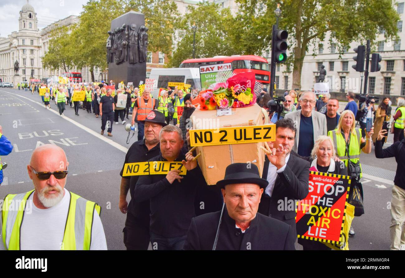 London, UK. 29th Aug, 2023. Protesters carry a mock coffin with anti-ULEZ signs during the demonstration. Anti-ULEZ protesters gather outside Downing Street as the ULEZ (Ultra Low Emission Zone) expansion takes effect. Credit: SOPA Images Limited/Alamy Live News Stock Photo