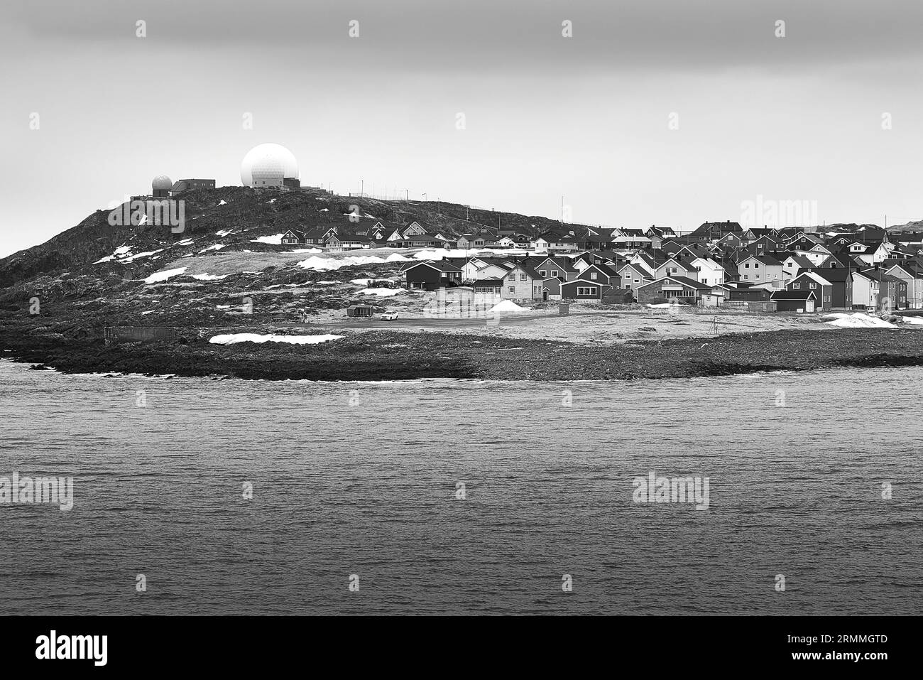 Black And White Photo Of The Norwegian Arctic Town Of Vardø. The Skyline Dominated By The Radar Domes Of The GLOBUS Radar Station, Vardø, Norway Stock Photo