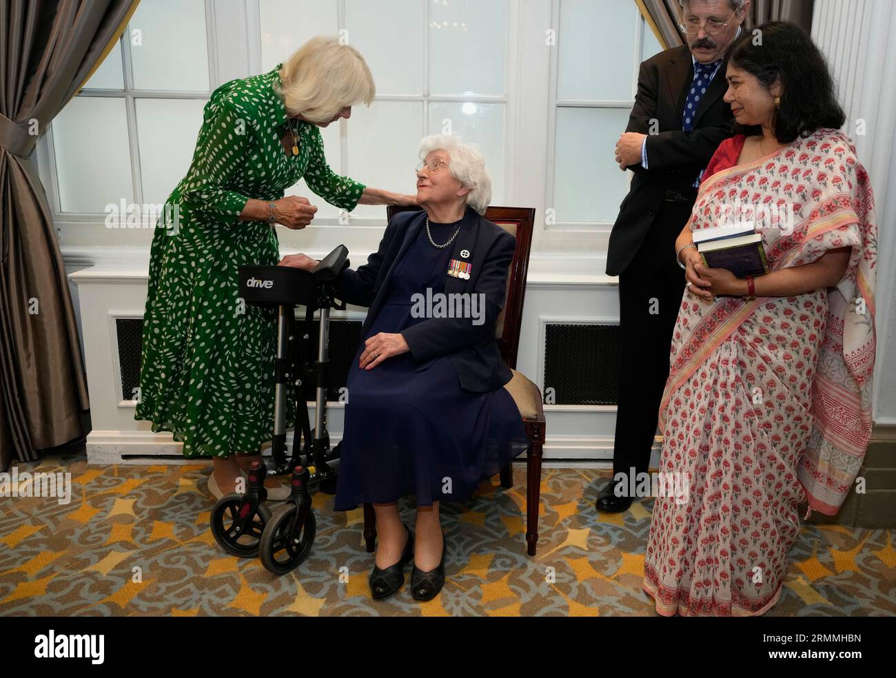 Queen Camilla (left) meets meets Mildred Schutz, 99, a former Special Operations Executive (SOE) at the Royal Air Force Club in Piccadilly, central London, where she unveiled a portrait of SOE Operative, Noor-un-Nisa Inayat Khan GC, and formally announced the naming of a room in her honour. Picture date: Tuesday August 29, 2023. Stock Photo