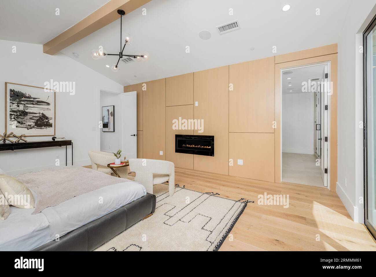 Image showcasing A modern bedroom with white and wood accents and a vaulted ceiling ...