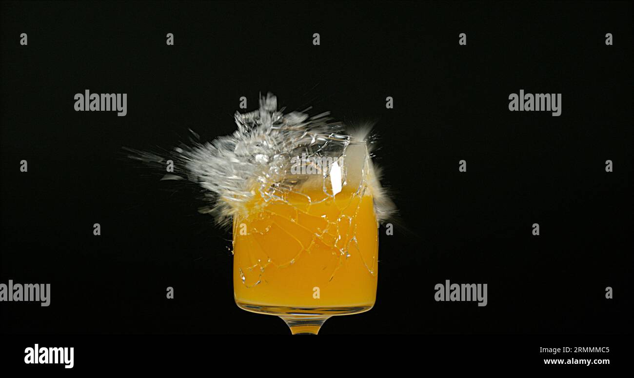 Glass of Orange Exploding against Black Background Stock Photo - Alamy