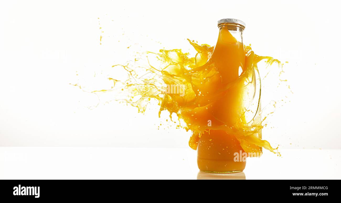 Bottle of Orange Exploding against White Background Stock Photo - Alamy