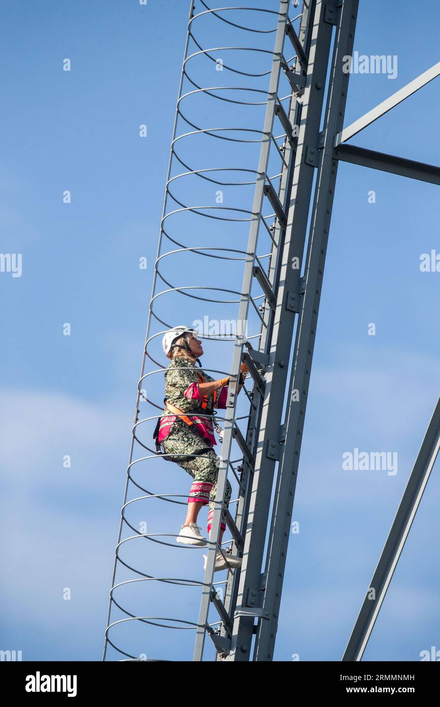 TV host Anne Lundberg, Sveriges Television, climbs the Motala radio towers  in connection with a report when the TV program Antikrundan has arrived in  the city of Motala, Sweden, during Monday afternoon.