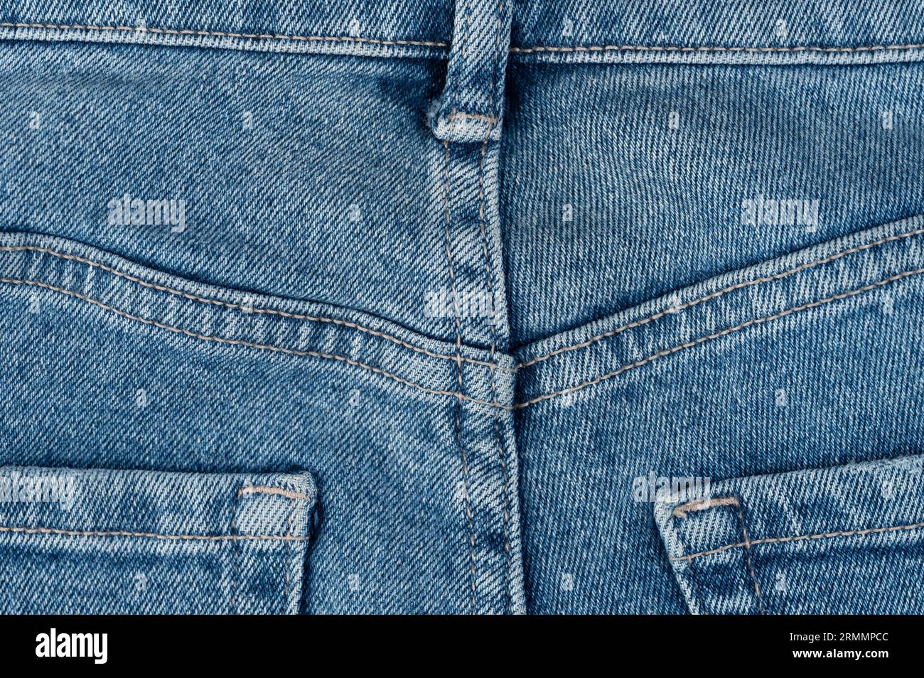 Blue jeans background with stitches and pockets close up view Stock Photo