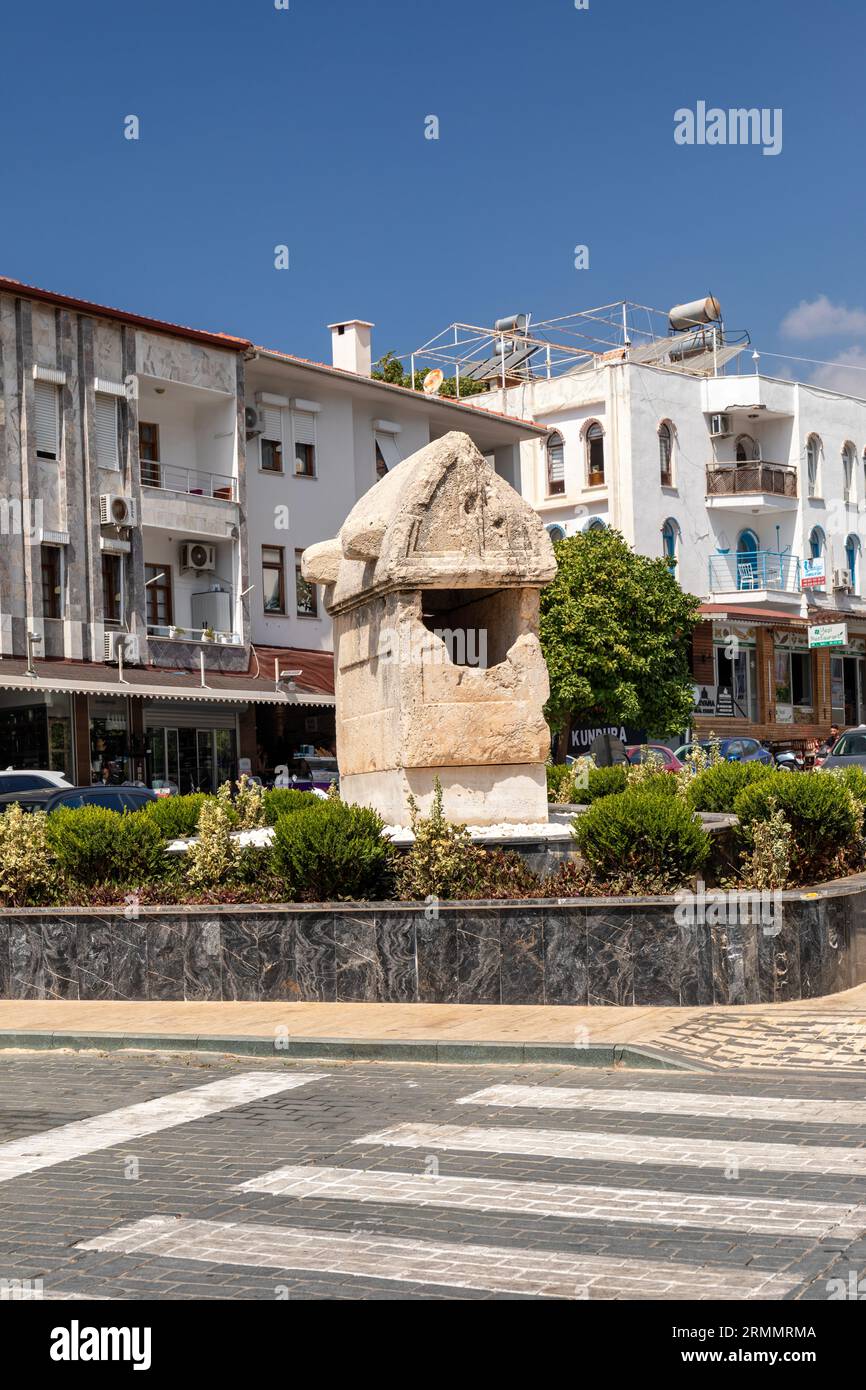 An old Lycian tomb on the roundabout in the the town centre of Kas, Turkey. Stock Photo