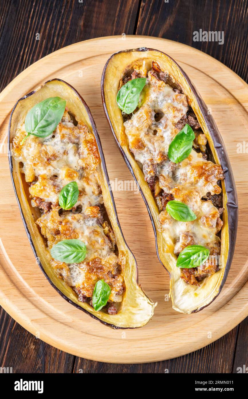 Sausage stuffed eggplant boats with melted cheese Stock Photo Alamy