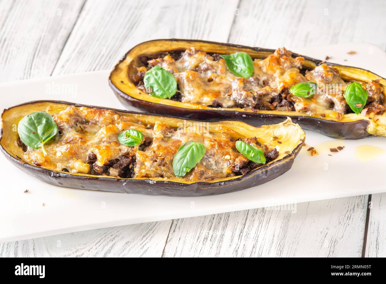 Sausage stuffed eggplant boats with melted cheese Stock Photo Alamy