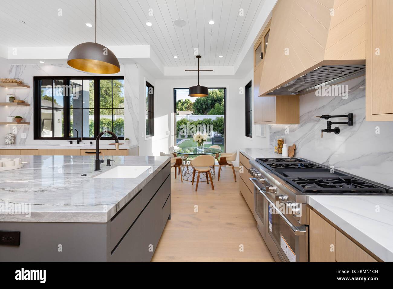 A luxurious home with a spacious kitchen featuring a large kitchen island  and stylish marble countertops Stock Photo - Alamy, image size:1300x956