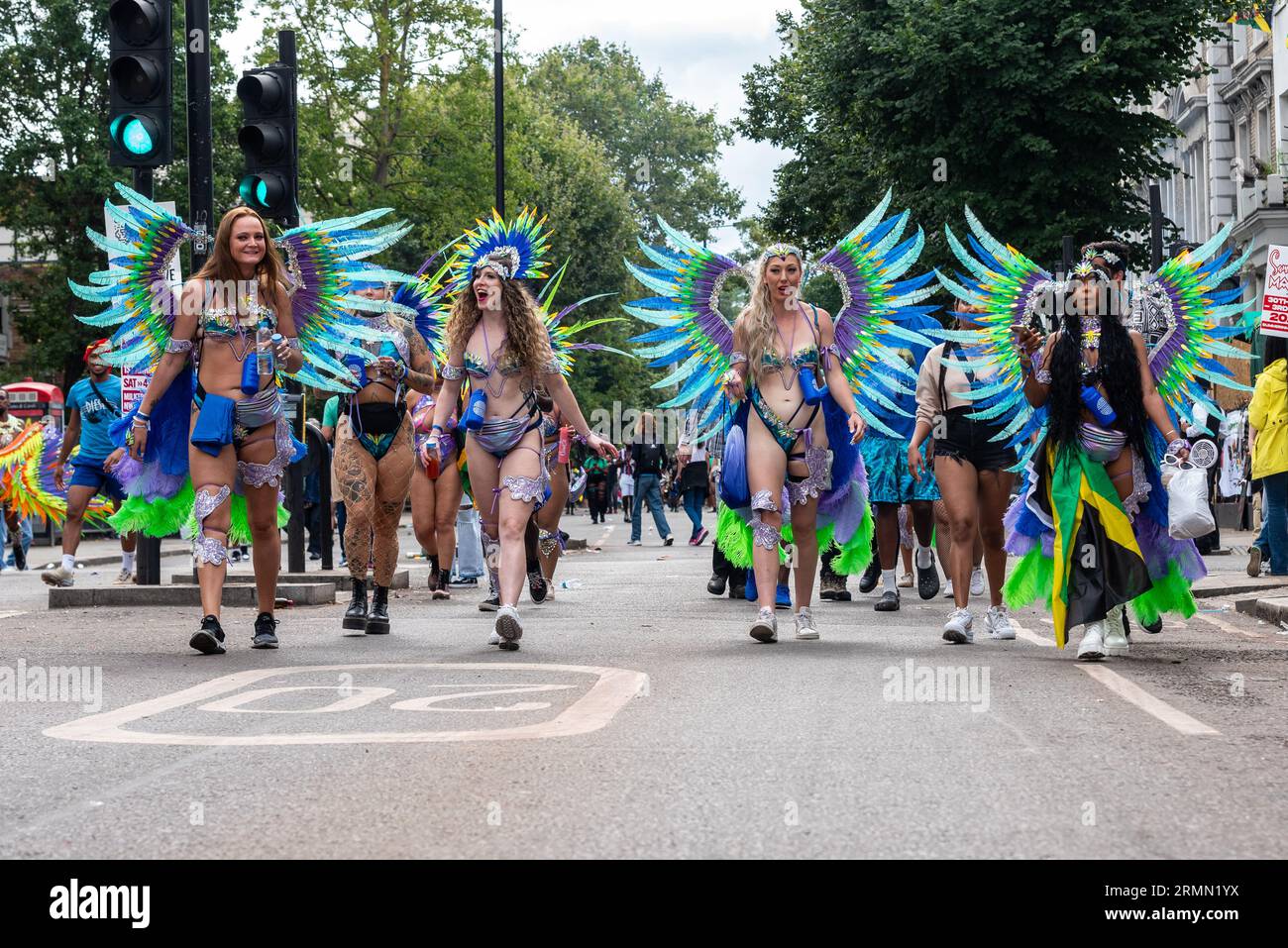 Female participants arriving at the Notting Hill Carnival Grand Parade 2023, London, UK. White Caucasian women in elaborate costumes Stock Photo
