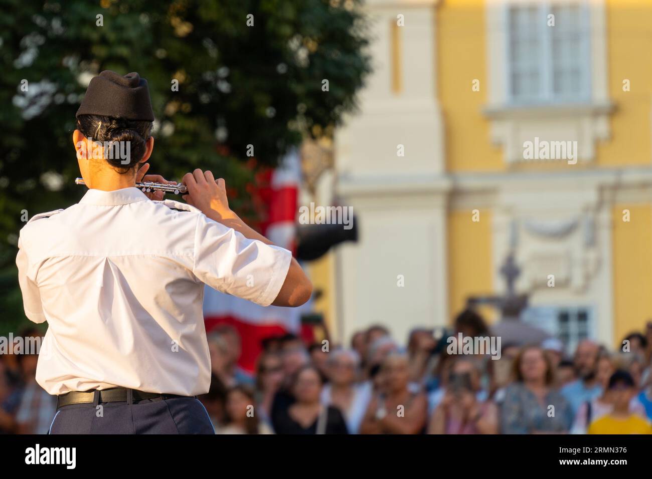 Woman playing flute in uniform in a military band Stock Photo