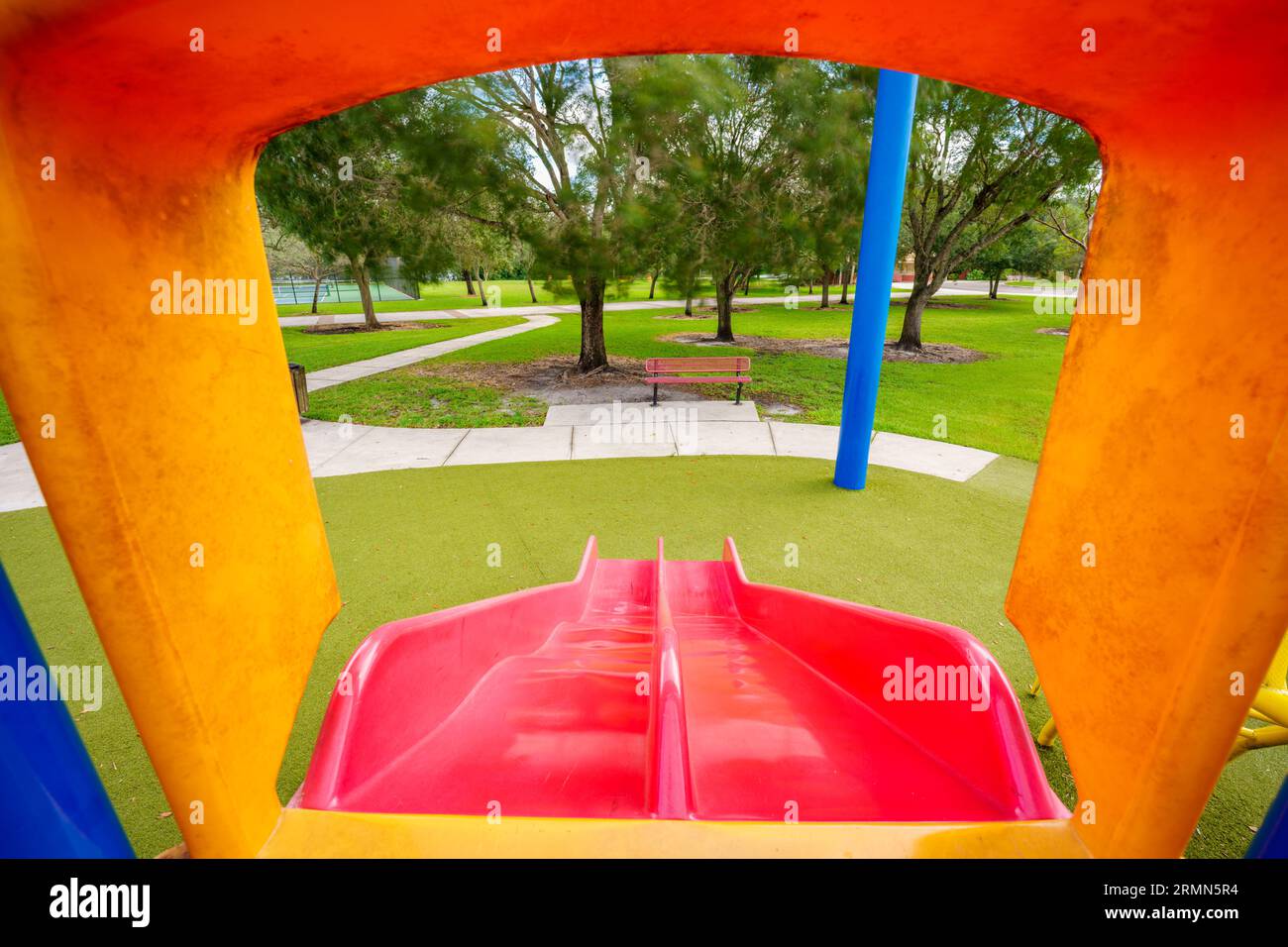Childs pov looking down a slide in a playground Stock Photo