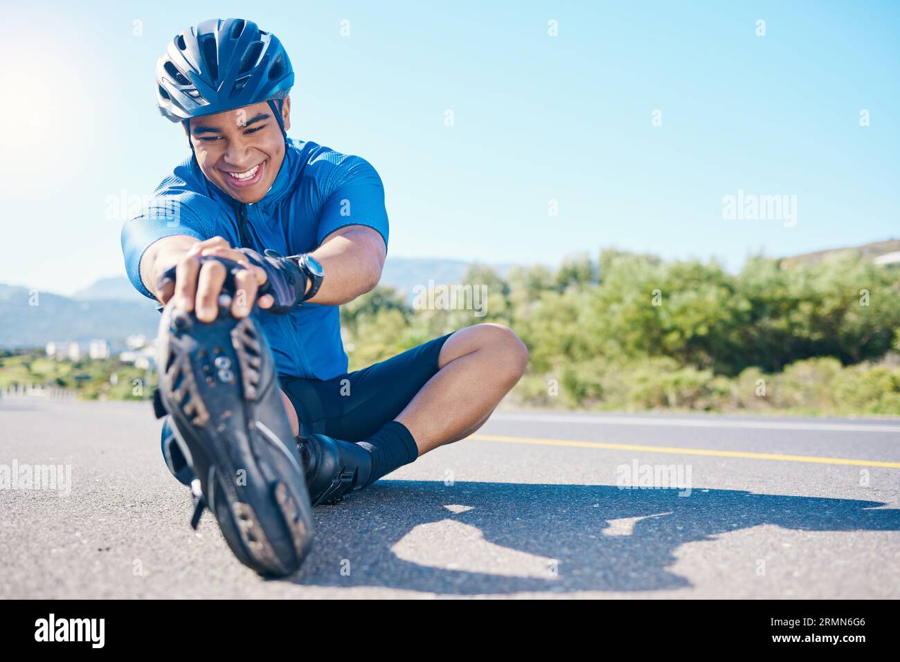 Happy man cyclist and stretching on road in fitness outdoor