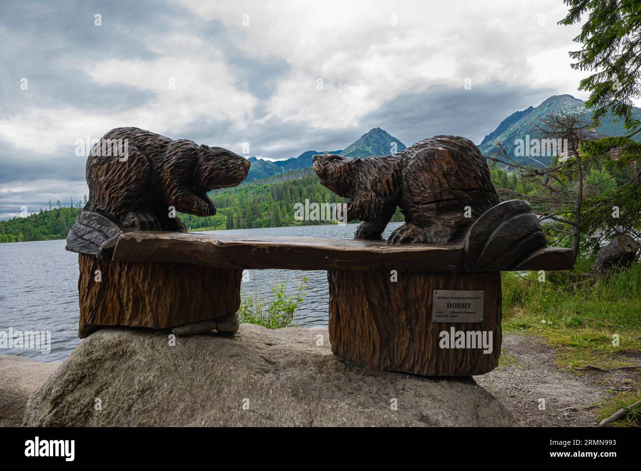 Wooden beavers on a table on the shore of a lake in the Tatra mountains of Slovakia. Stock Photo