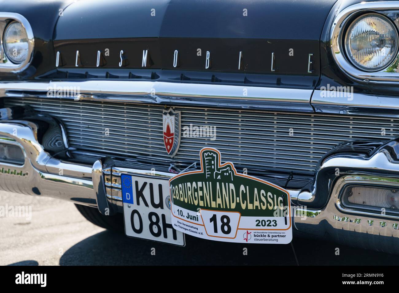 Waltershausen, Germany - June 10, 2023: A vintage American Oldsmobile Rocket Super 88 is parked in front of a Burgenland classic. Front view of headli Stock Photo