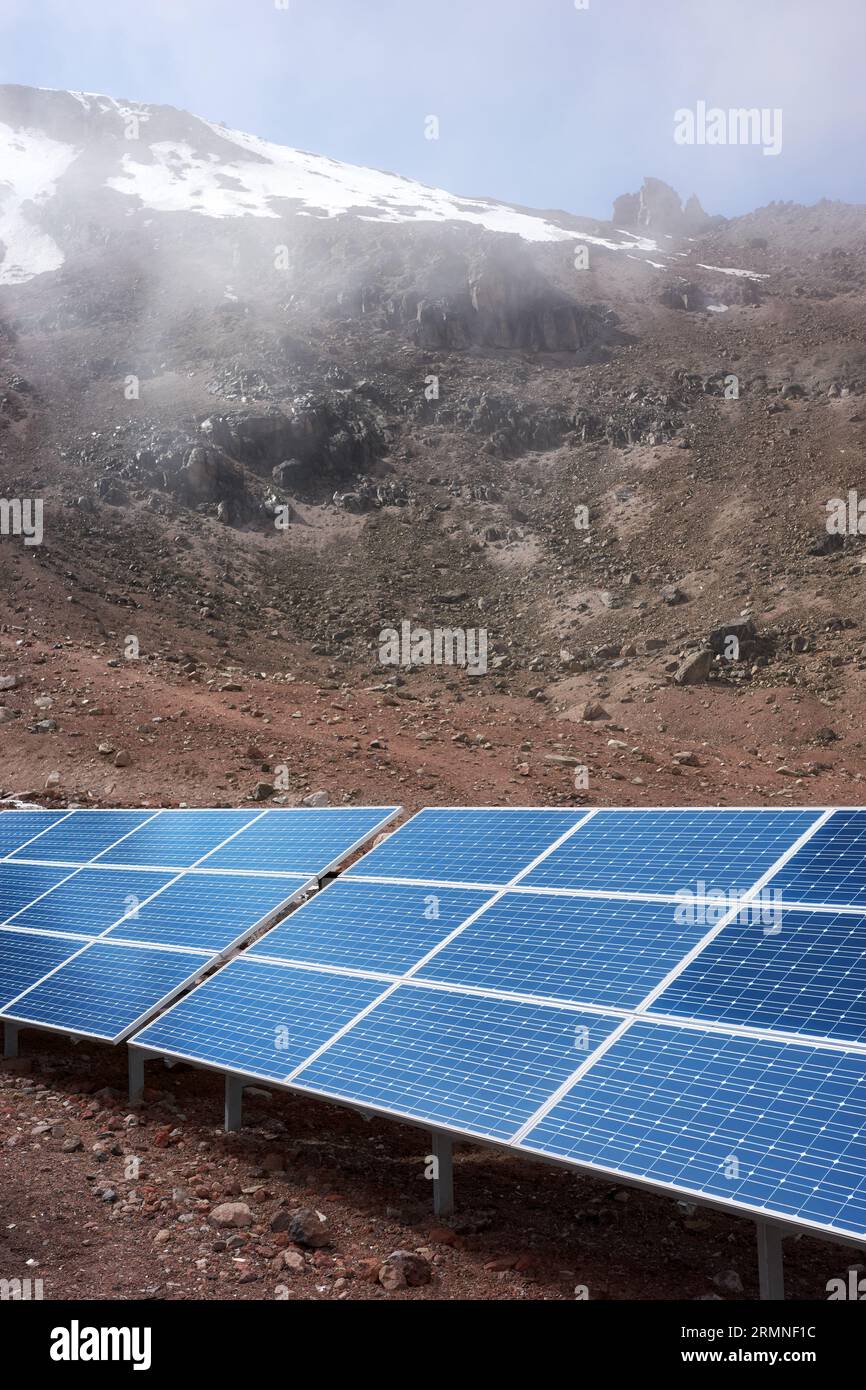 Solar panels with Chimborazo volcano in background, selective focus, Ecuador. Stock Photo