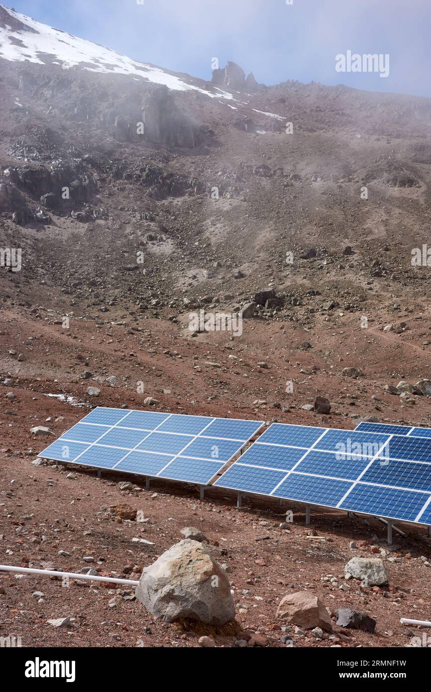 Solar panels with Chimborazo volcano in background, selective focus, Ecuador. Stock Photo