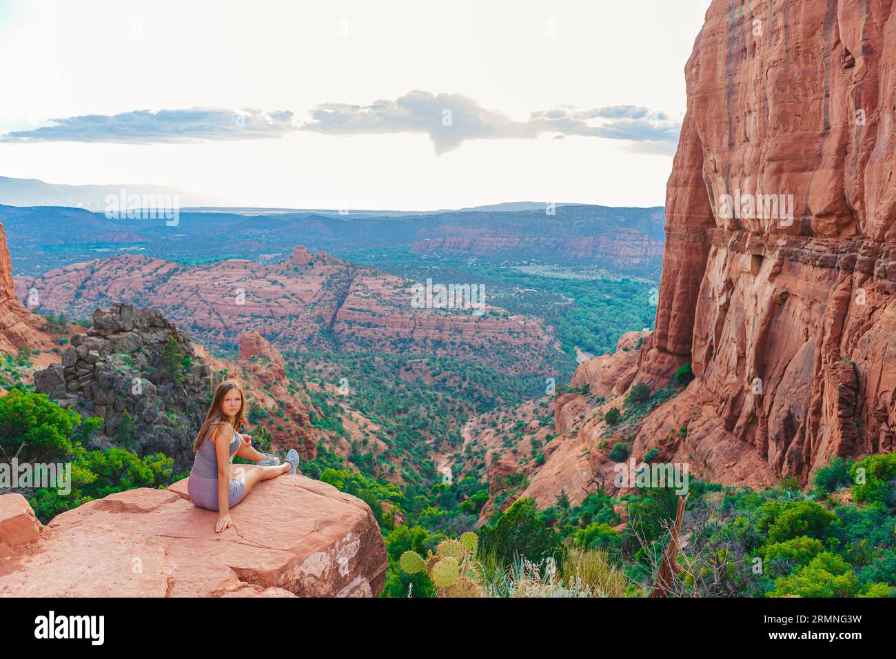 Little girl on the edge of a cliff at Cathedral Rock in Sedona, Arizona ...