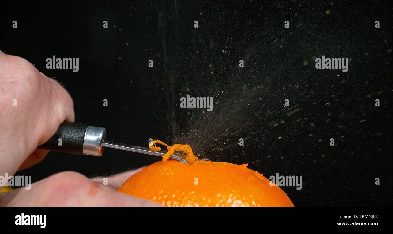 Orange zest, citrus sinensis, against Black background Stock Photo