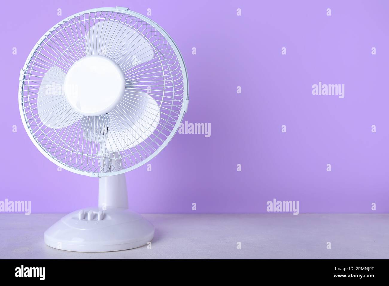 Electric fan on lilac background Stock Photo