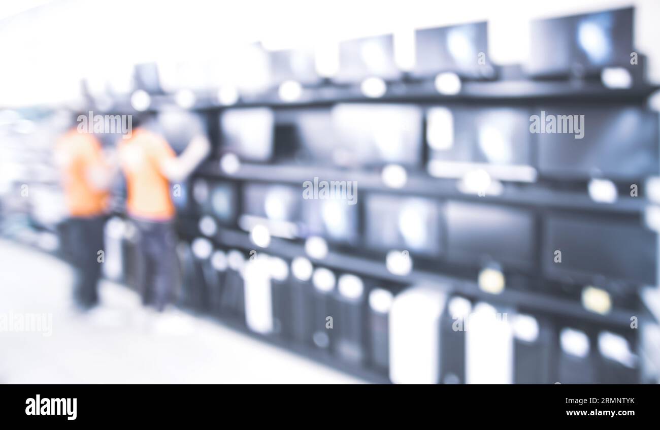 salesmen near TVs in electronics store Stock Photo Alamy
