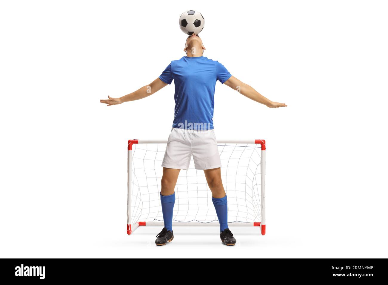 Football player holding a ball with head in front of a mini goal