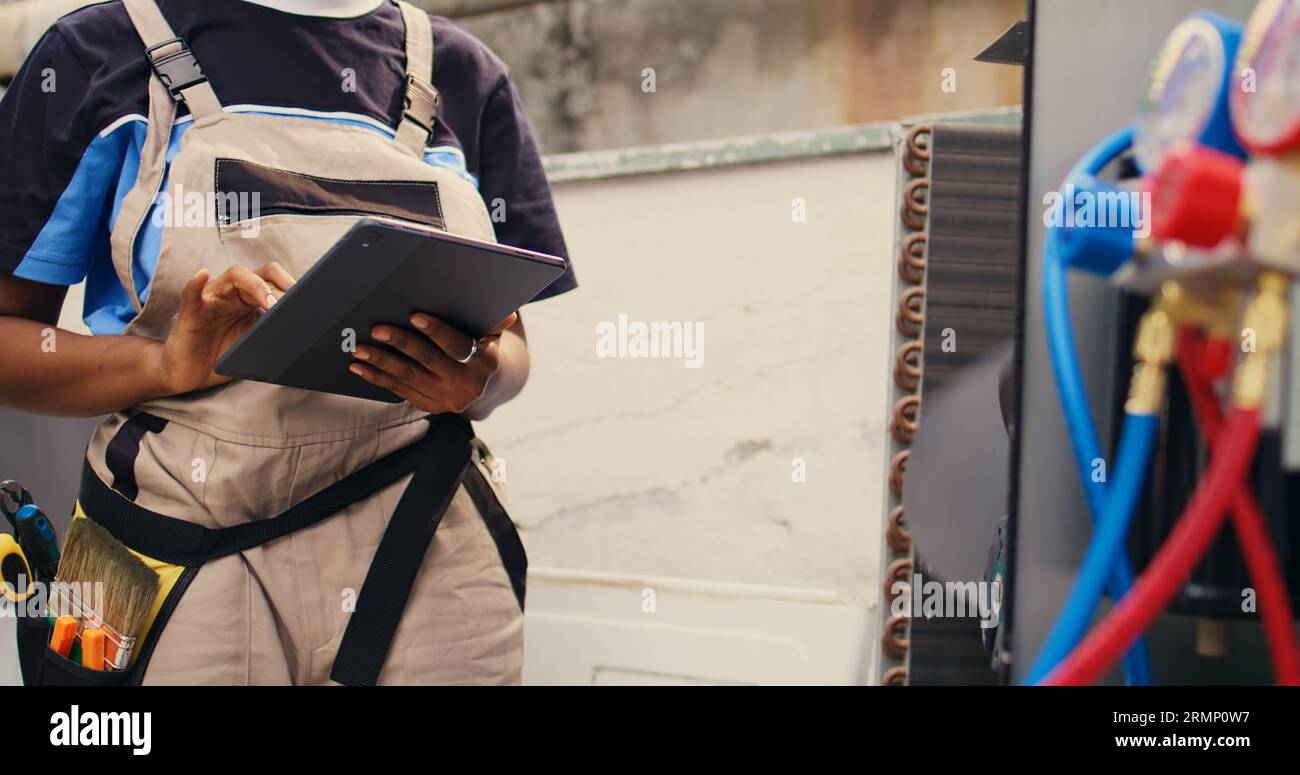 Close up of expert electrician calibrating ac gauges vacuum pump during