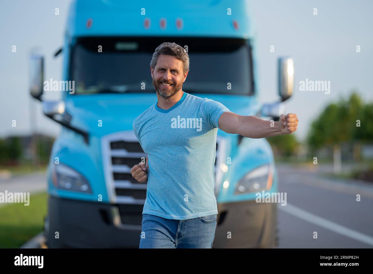 Relaxed Caucasian Truck Driver Seating on the Ground and Support His Back  on the Semi Truck Wheel Stock Photo - Alamy