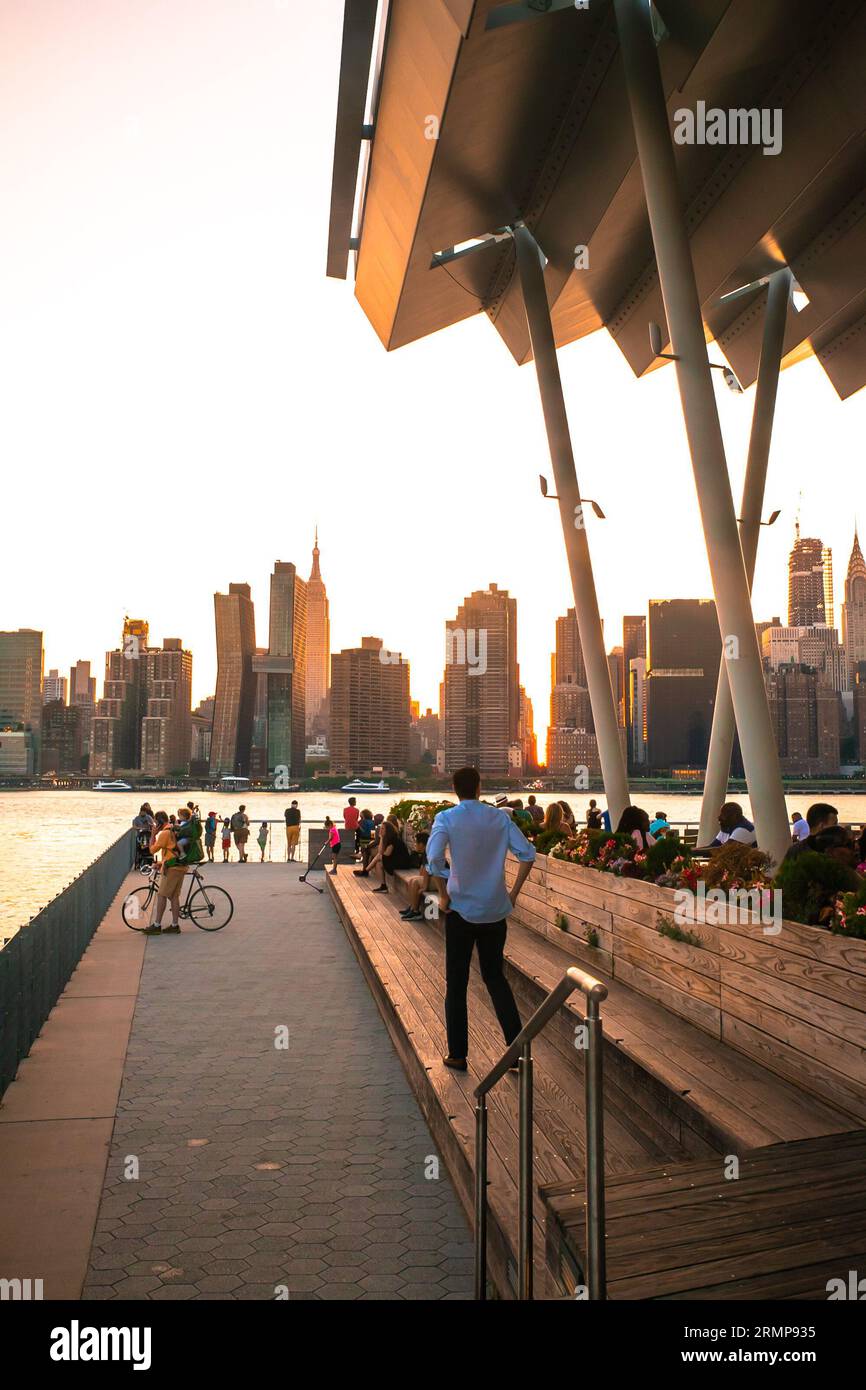 Long Island City, New York - July 13, 2019:  View at sunset from Gantry Plaza State Park in Queens New York City. Stock Photo