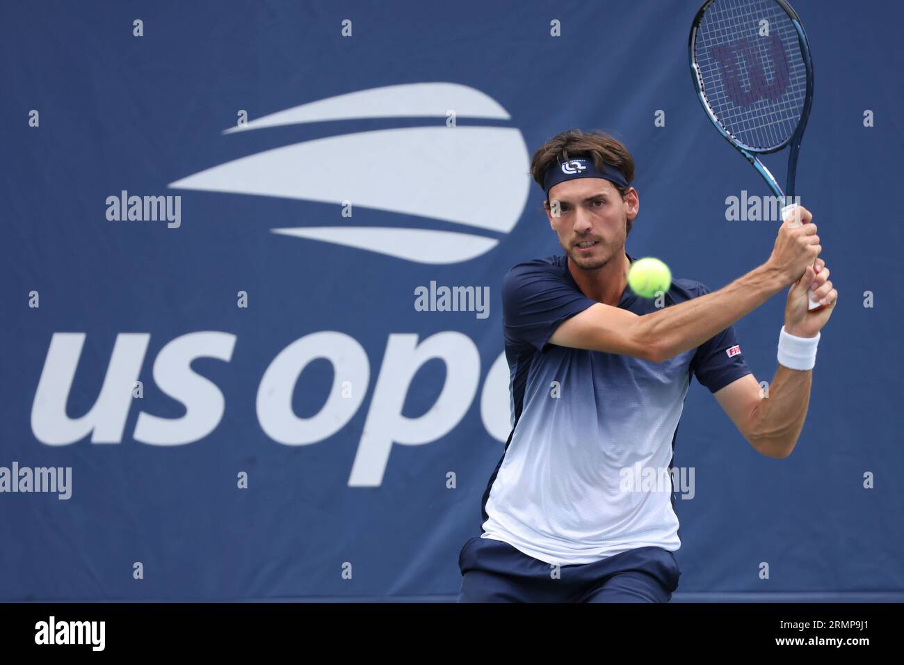 Marc-Andrea Huesler, of Switzerland, returns a shot to Hubert Hurkacz, of Poland, during the first round of the U.S. Open tennis championships, Tuesday, Aug