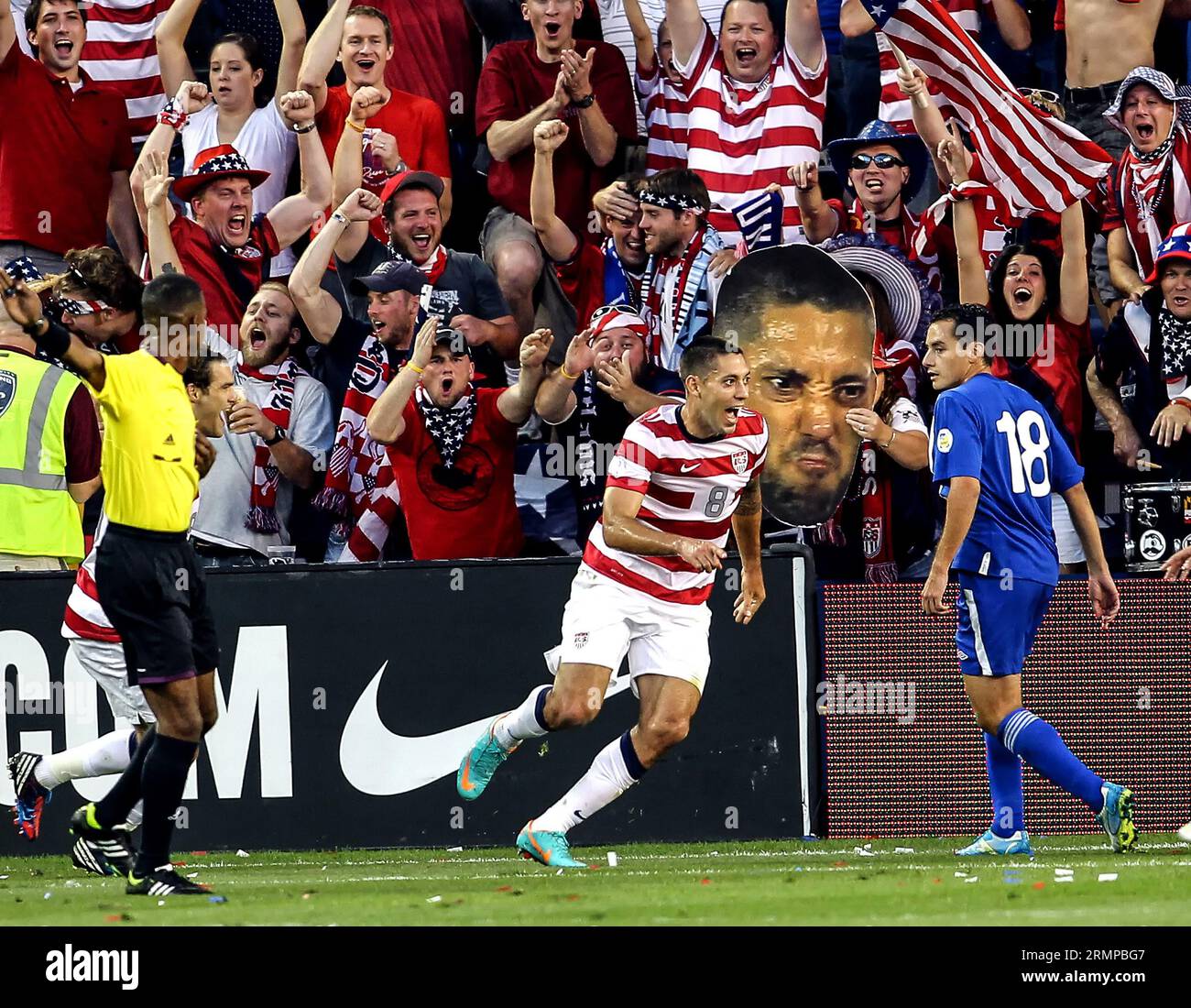 October16 2012:  Clint Dempsey (8)of the USA MNT and a cartoon likeness after he had scored and passes Carlos Figueroa (18) of  Guatemala during a CONCACAF semi-final World Cup qualifier at Livestrong Sporting Park, in Kansas City, KS. USA won 3-1. Stock Photo