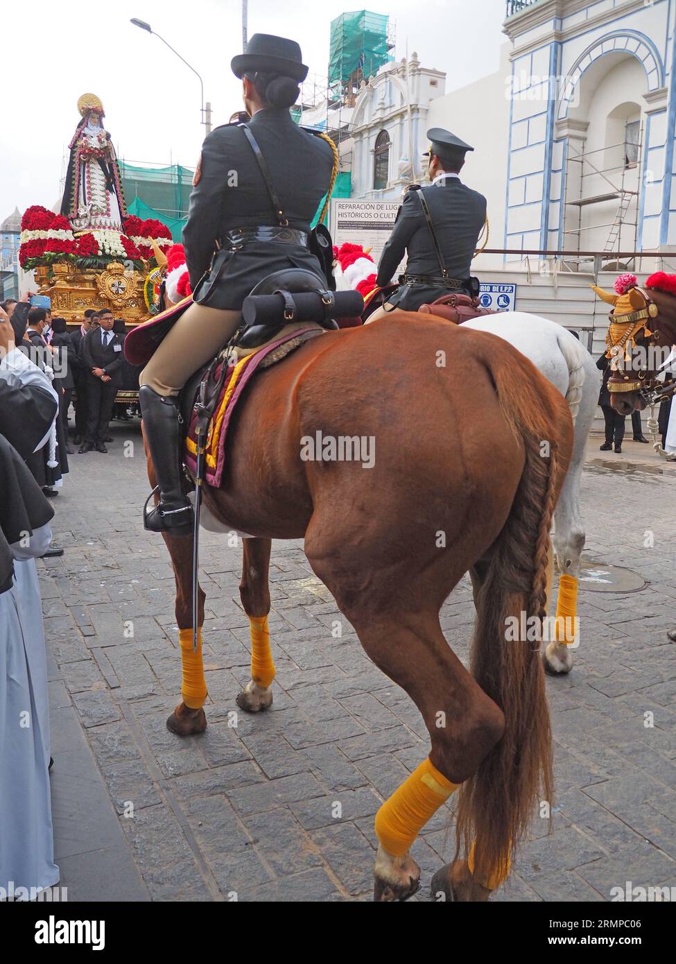 Lima, Peru. 29th Aug, 2023. National Police on horseback saluting when devotees carrying the image of Santa Rosa de Lima on their shoulders participating of the procession at Lima downtown as every august 30th. Saint Rose of Lima, born Isabel Flores de Oliva, 20 April 1586 - 24 August 1617, is the patroness of the Americas and National Police of Peru. Credit: Fotoholica Press Agency/Alamy Live News Stock Photo