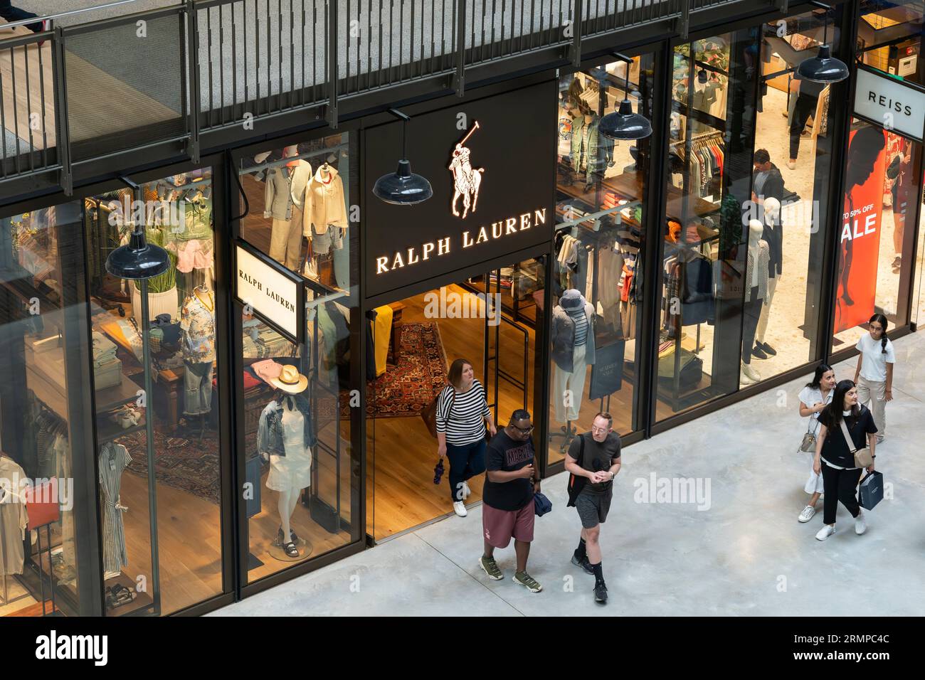 Shoppers browsing in a Ralph Lauren outlet store in Turbine Hall A within the refurbed Grade II* listed Battersea Power Station in London, England Stock Photo