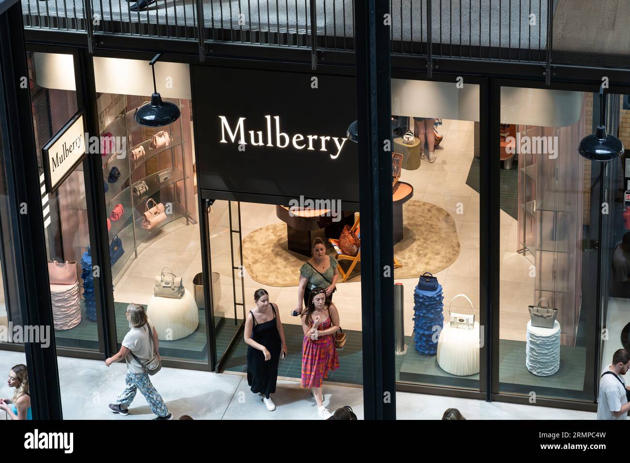 Shoppers browsing in a Mulberry outlet store in Turbine Hall A within the refurbed Grade II* listed Battersea Power Station in London, England Stock Photo