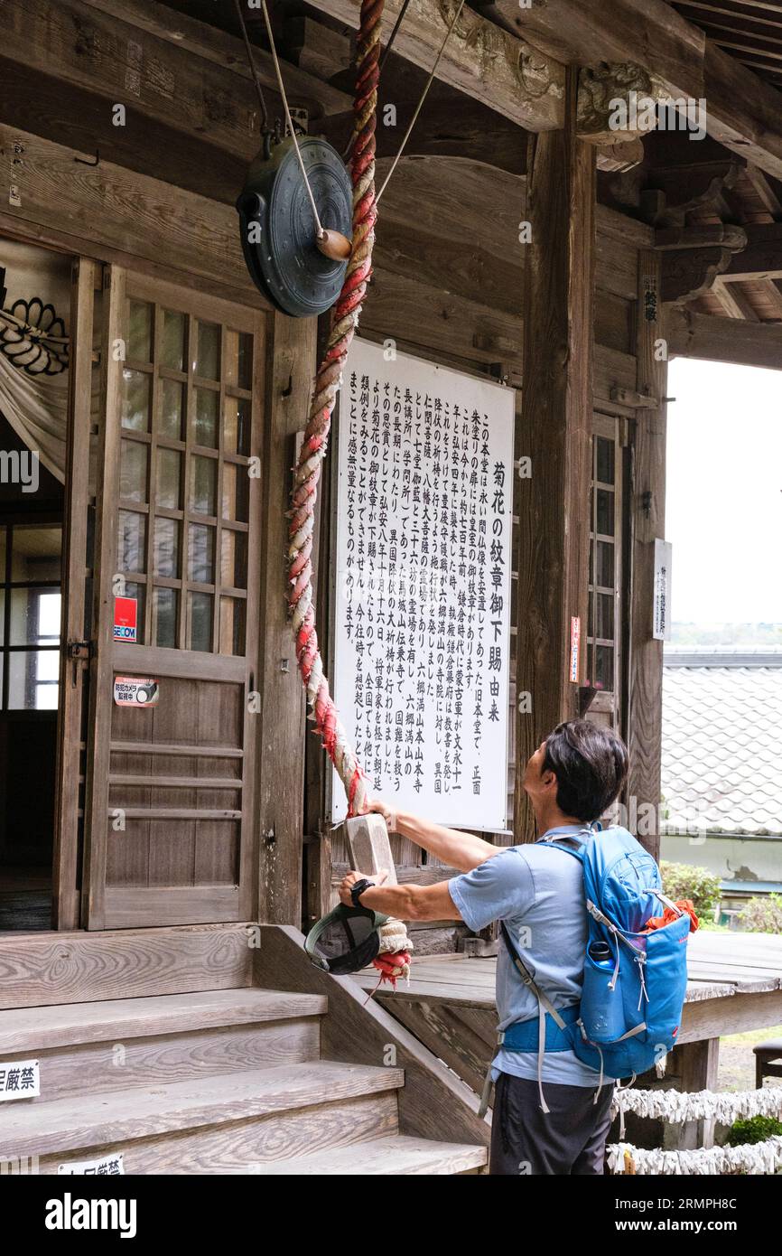 Japan, Kyushu. Makiodo Temple, Ringing the Temple Bell, or Gong Stock