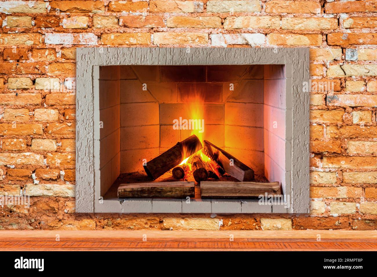 An ornate brick fireplace with a roaring fire burning in the hearth, emitting a warm and inviting glow Stock Photo