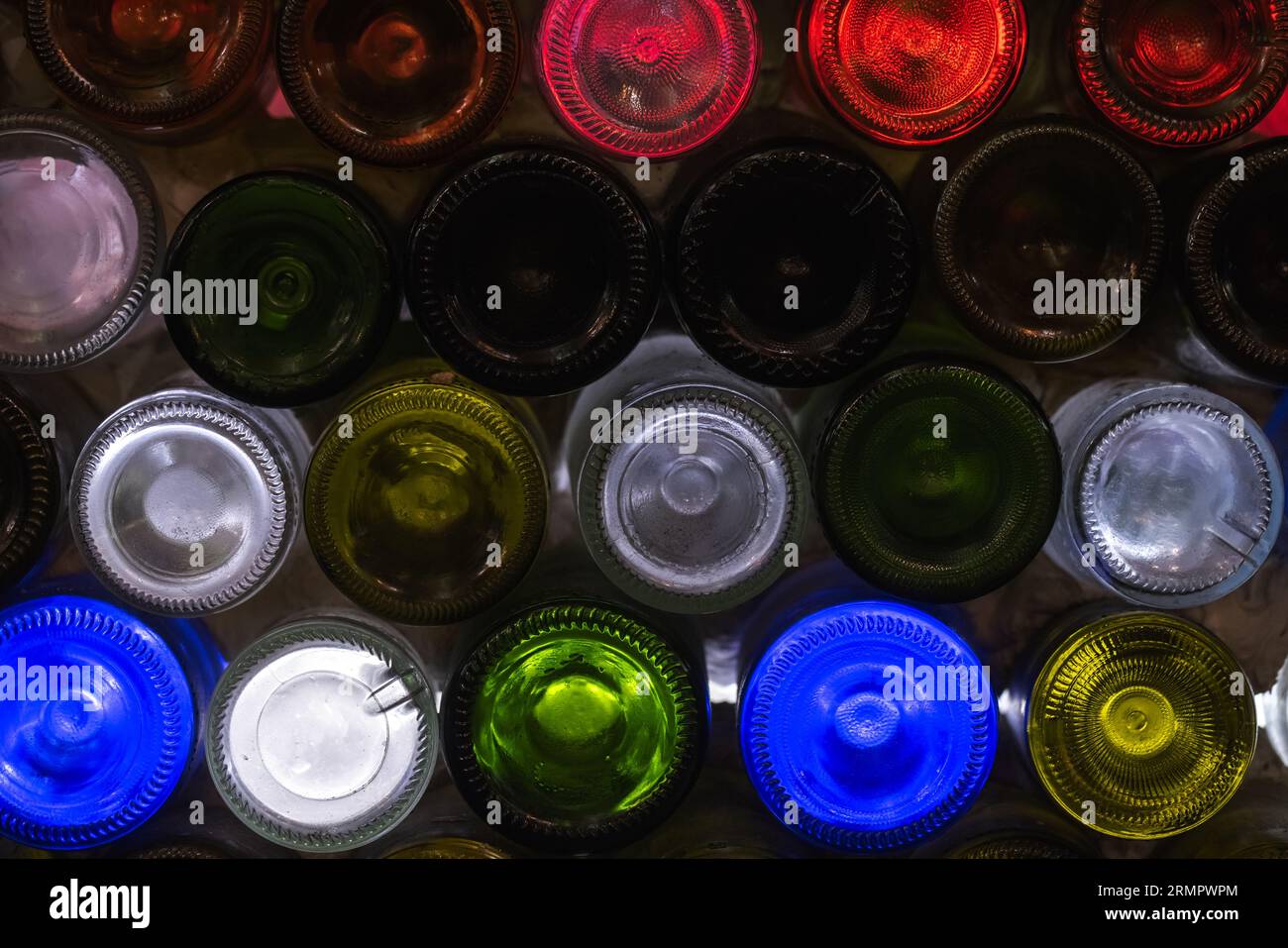 Decorative bar panel made of empty colorful transparent wine bottles