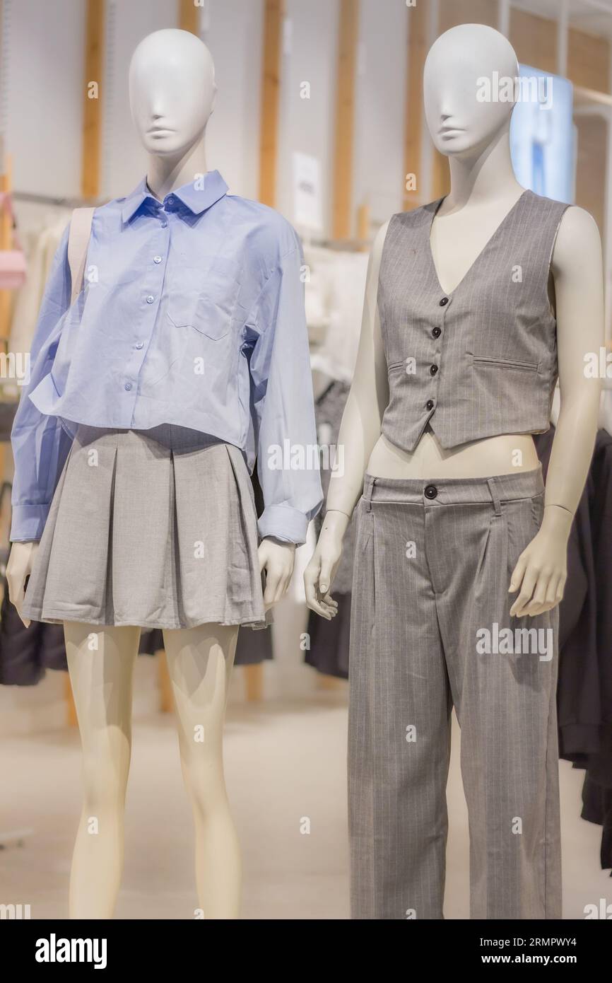 Mannequins in shop. New fashion collection on dolls. Mannequins in shopping mall. Woman clothing on the dolls. Outfit concept. Dolls in show window. Stock Photo