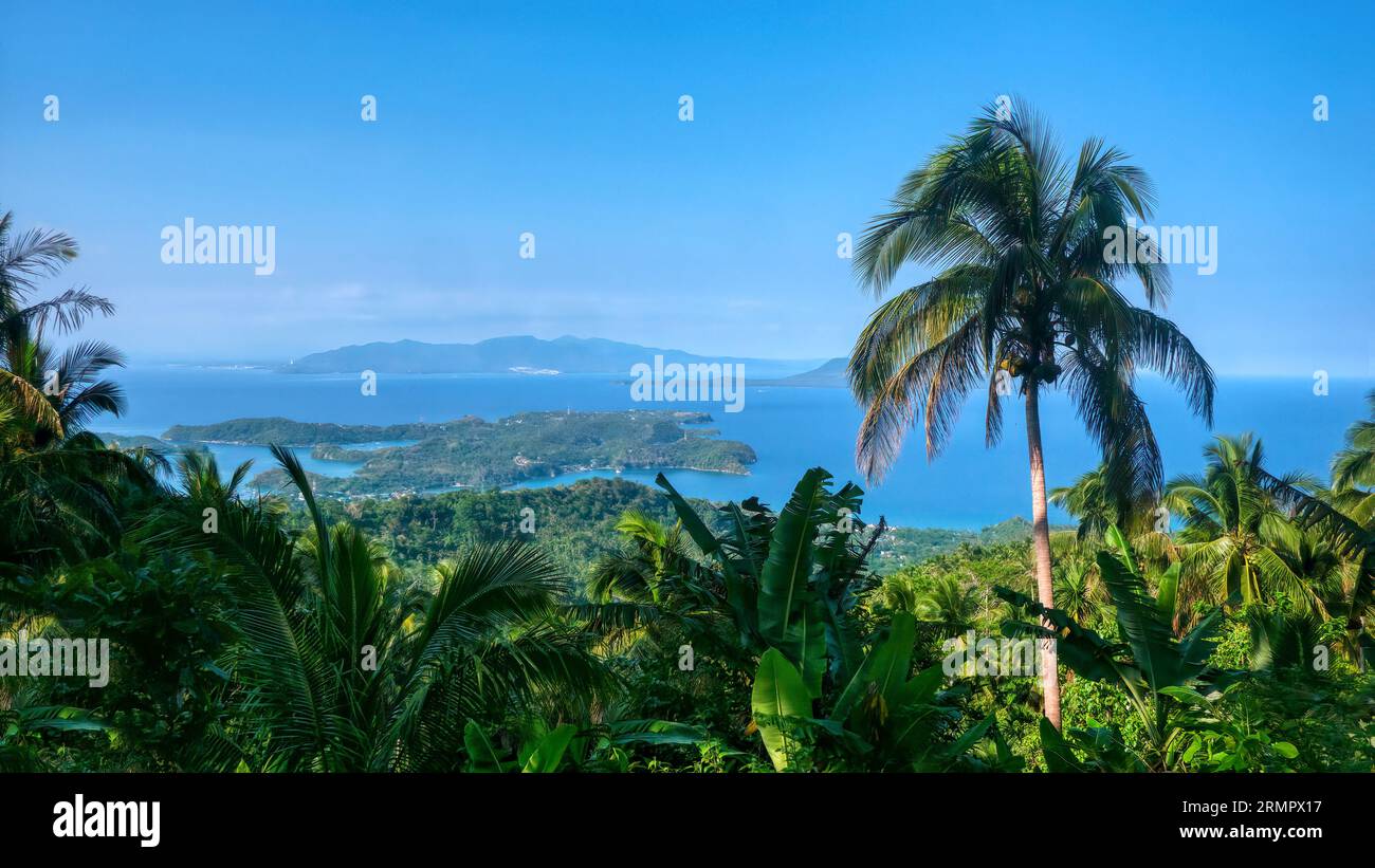 Wide angle view of the Philippines coastal resort area of Puerto Galera on Mindoro Island, the Verde Island Passage, and Luzon Island in the distance. Stock Photo