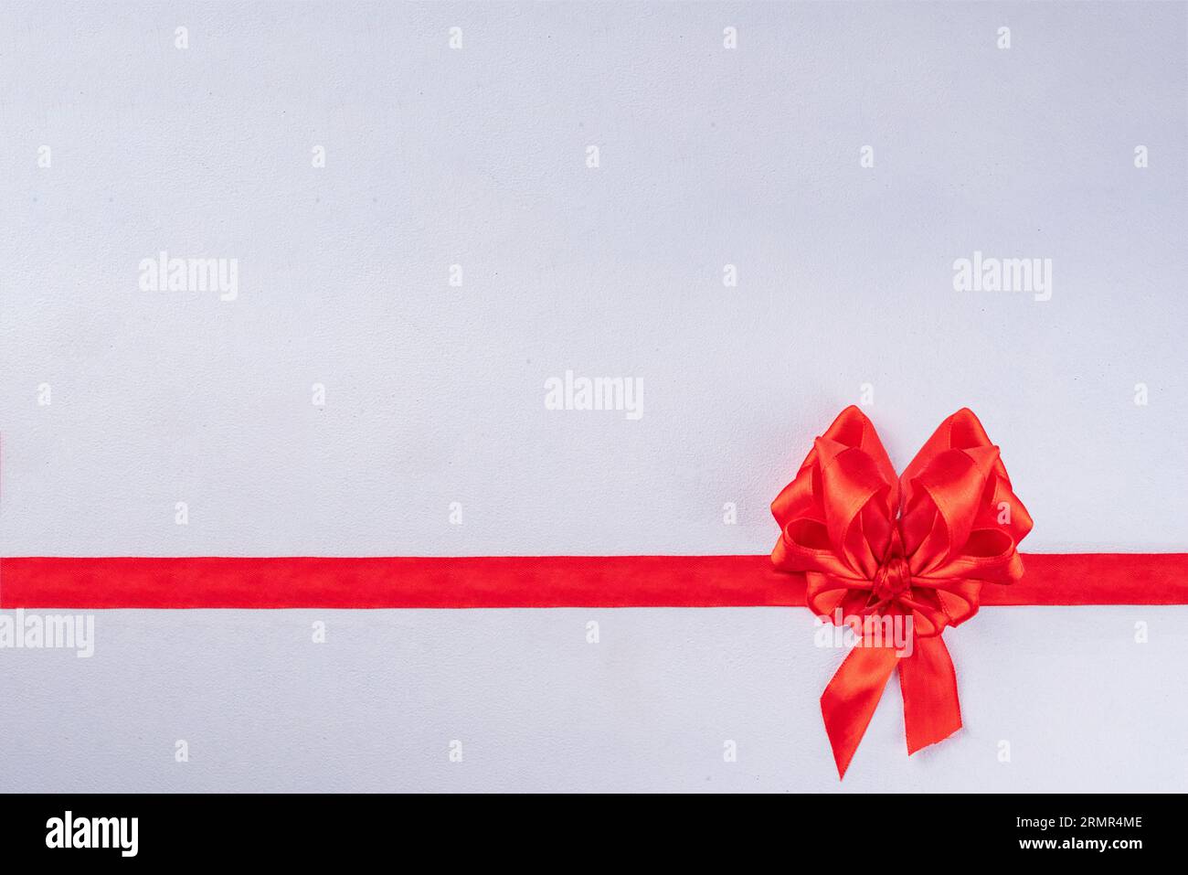Heart shaped festive red bow and ribbon isolated on white background ...
